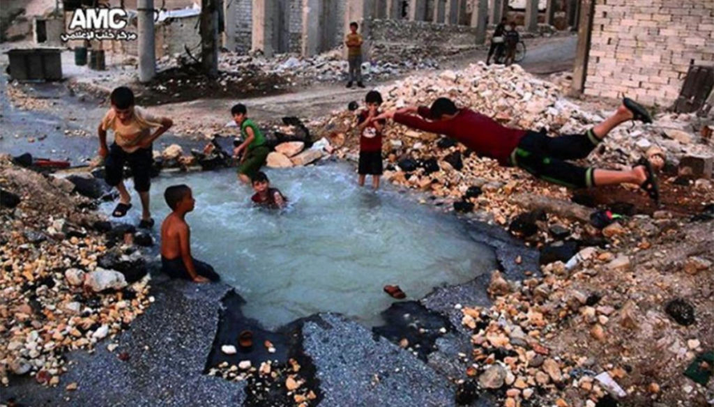 Aleppo children beyond horror: the bomb crater becomes their swimming pool