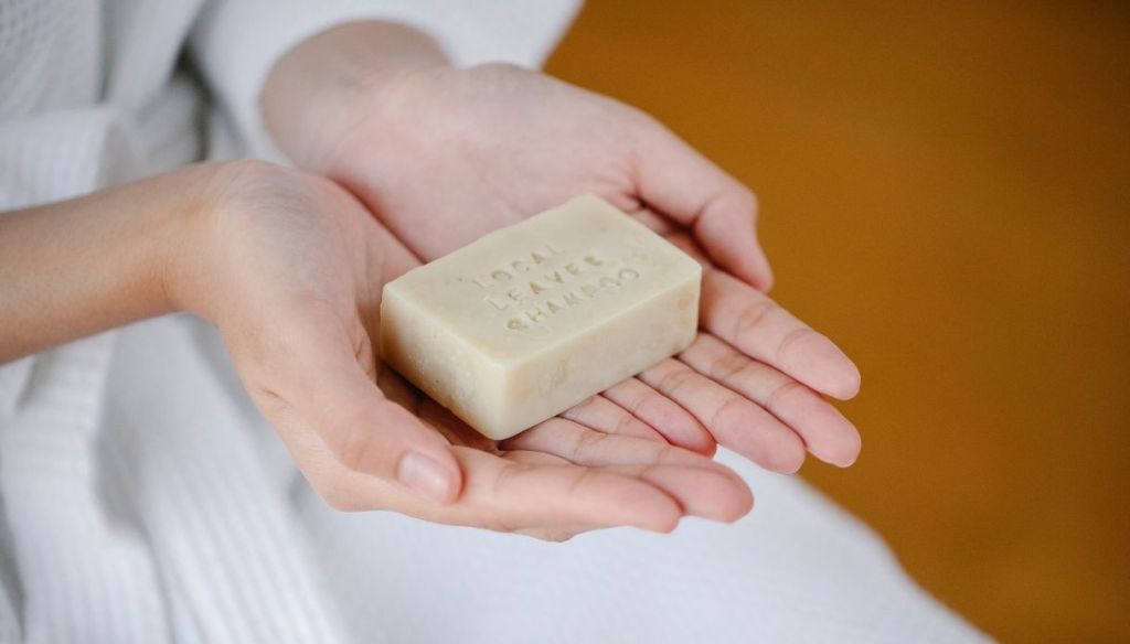woman hands solid shampoo soap bar