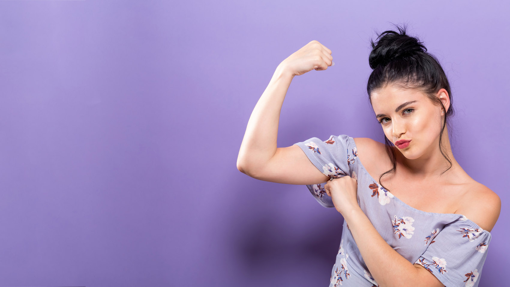 woman shows arm muscle, confidence, self confidence