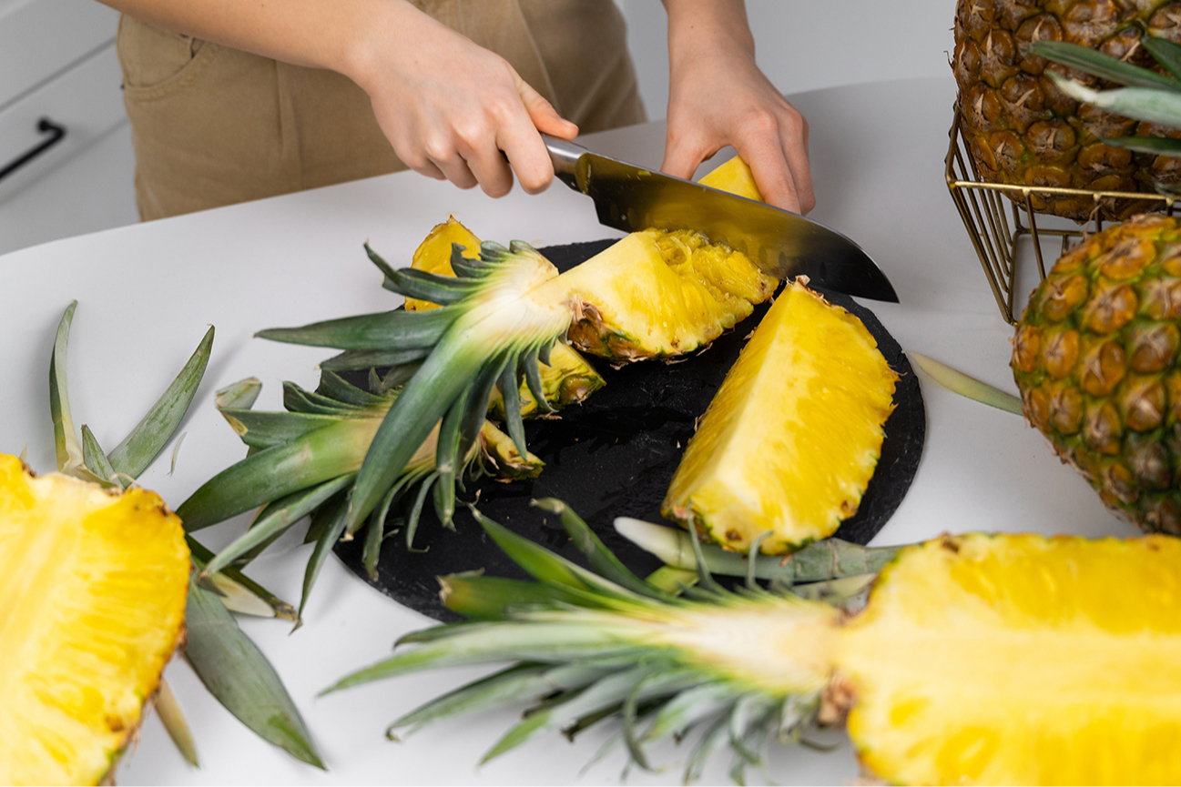 To peel a pineapple, you first need to cut off the stem, then cut off the top with leaves, and then cut off the scales